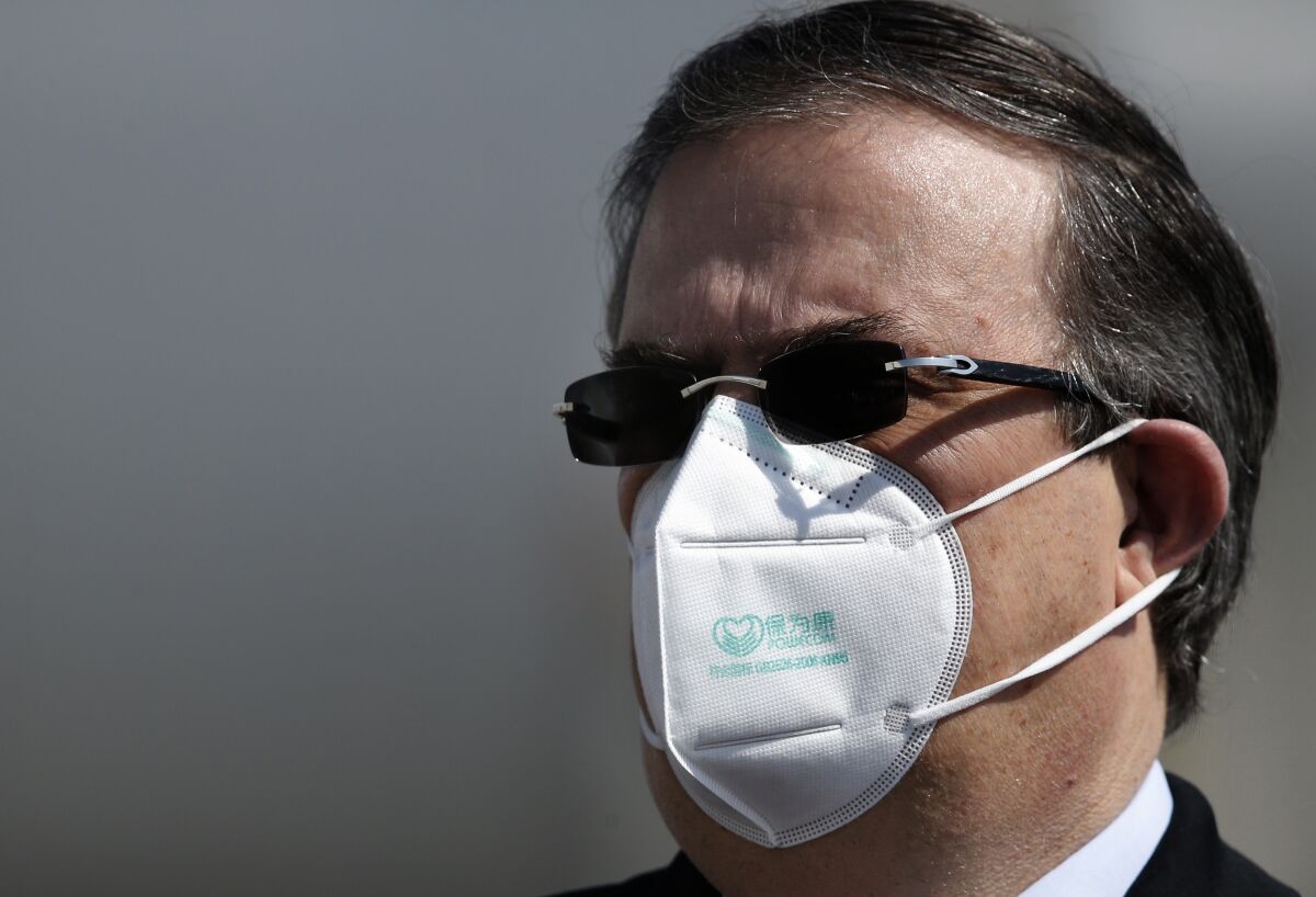 Mexican Foreign Minister Marcelo Ebrard wears a mask against the spread of the coronavirus.