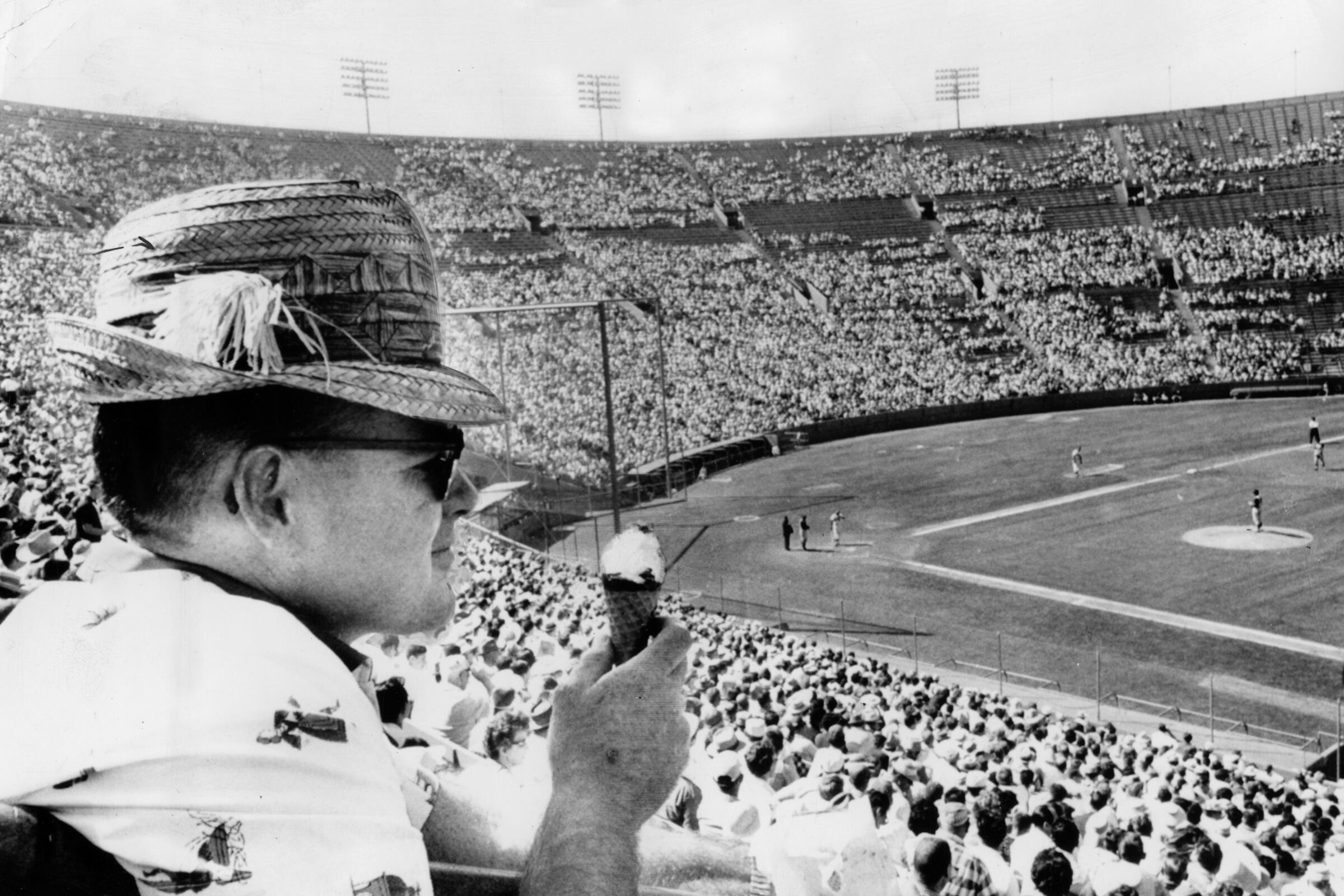 A Dodgers fan eats ice cream cone during game in April 1961 at the Coliseum.
