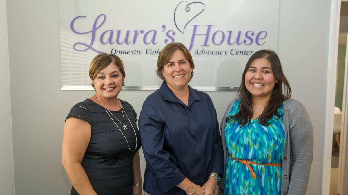 LGBT Center OC executive director Peg Corley, center, with Laura's House executive director Margaret Bayston, left, and prevention education specialist Yanira Mendez. Laura's House is partnering with LGBT Center OC to provide all community members with domestic violence support.