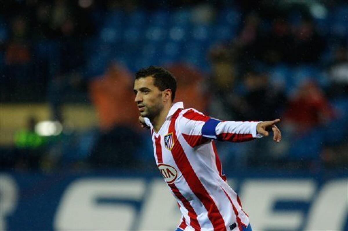 Atletico de Madrid's Simao Sabrosa from Portugal celebrates after scoring a penalty against Espanyol during his Spanish Copa del Rey soccer match at the Vicente Calderon stadium in Madrid, Wednesday, Dec. 22, 2010. (AP Photo/Arturo Rodriguez)