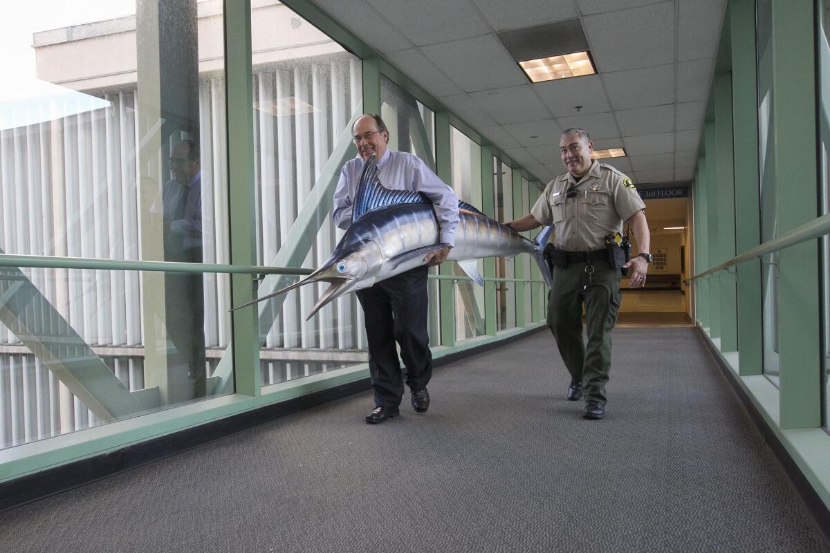 Judge Frederick Link carries his catch to his chambers in the new courthouse building in 2018