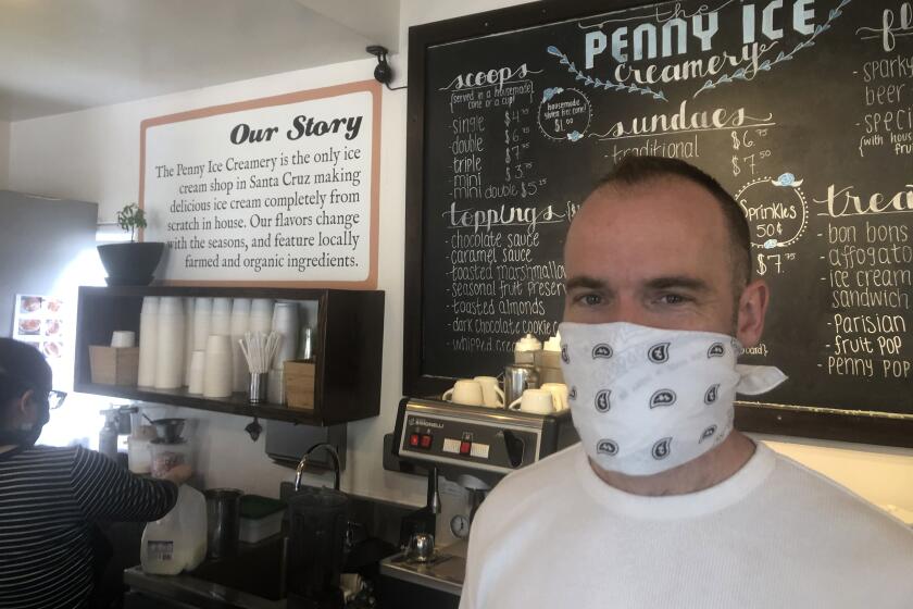 In this April 17, 2020, photo, Zachary Davis poses for a photo at The Penny Ice Creamery in Santa Cruz, Calif. An investigation by The Associated Press hows that many large companies which collectively received tens of millions of dollars in federal loans through the Paycheck Protection Program were at risk of failing even before the coronavirus walloped the economy, while others have acknowledged problems keeping their finances straight and a few have been under investigation by the Securities and Exchange Commission. That big companies and ones with questionable records received such precious financial aid during the chaotic last few weeks frustrates Davis, “We were feeling pretty good about where we were in the world. Now it’s just all turned upside down,” said Davis, who had to lay off 70 workers. (AP Photo/Martha Mendoza)