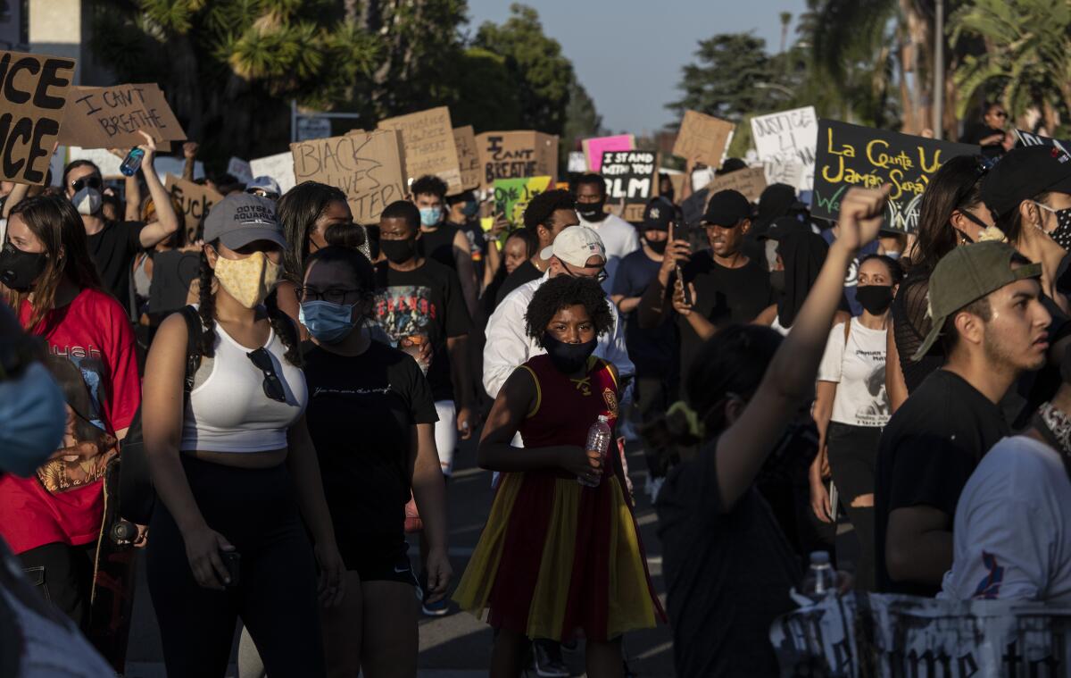 Protesters walk through a residential neighborhood in Hollywood on Wednesday.