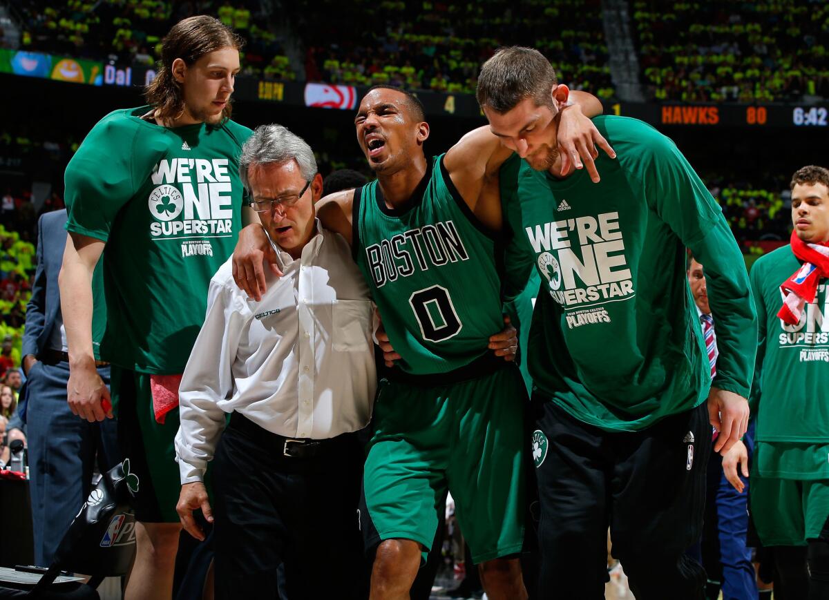Celtics guard Avery Bradley (0) is assisted off the court after an injury in Game 1 of the Eastern Conference playoffs against the Atlanta Hawks.
