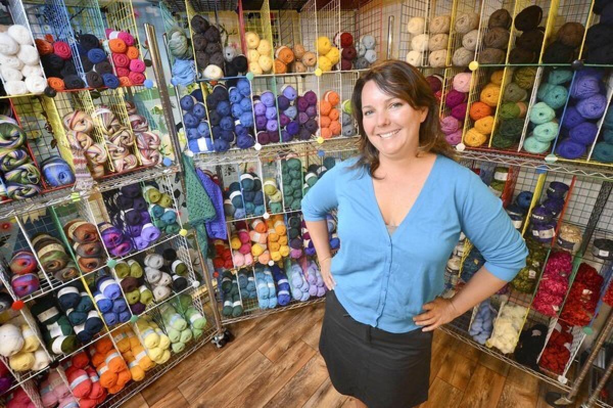 Jennifer Nimmrichter, owner of Suzoos Wool Works in Costa Mesa, in front of only a small sample of what her shop has to offer.