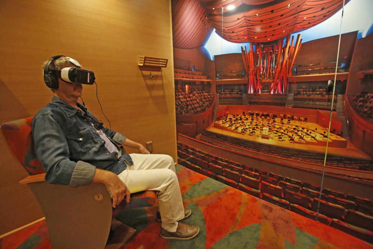Neal Taylor watches and listens a Los Angeles Philharmonic performance via a virtual reality headset in the orchestra's Van Beethoven.