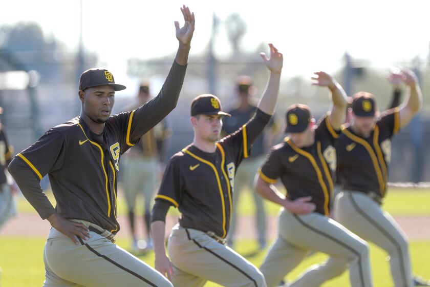 The Padres' Dauris Valdez, left, MacKenzie Gore, second from left, and other pitchers stretch on a field during Padres spring training at the Peoria Sports Complex on Thursday, February 13, 2020 in Peoria, Arizona.