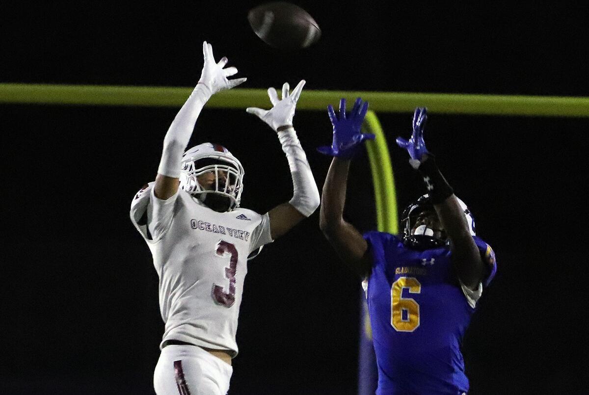 Ocean View's Romeo Lozano (3) tries to intercept a pass thrown to Gahr's Markell Slaughter (6) on Friday.