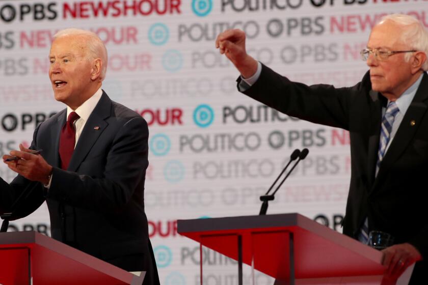 emocratic presidential candidate Sen. Bernie Sanders, I-Vt., right, raise his hands as former Vice President Joe Biden makes a p;oint during a Democratic presidential primary debate Thursday, Dec. 19, 2019, in Los Angeles, Calif.