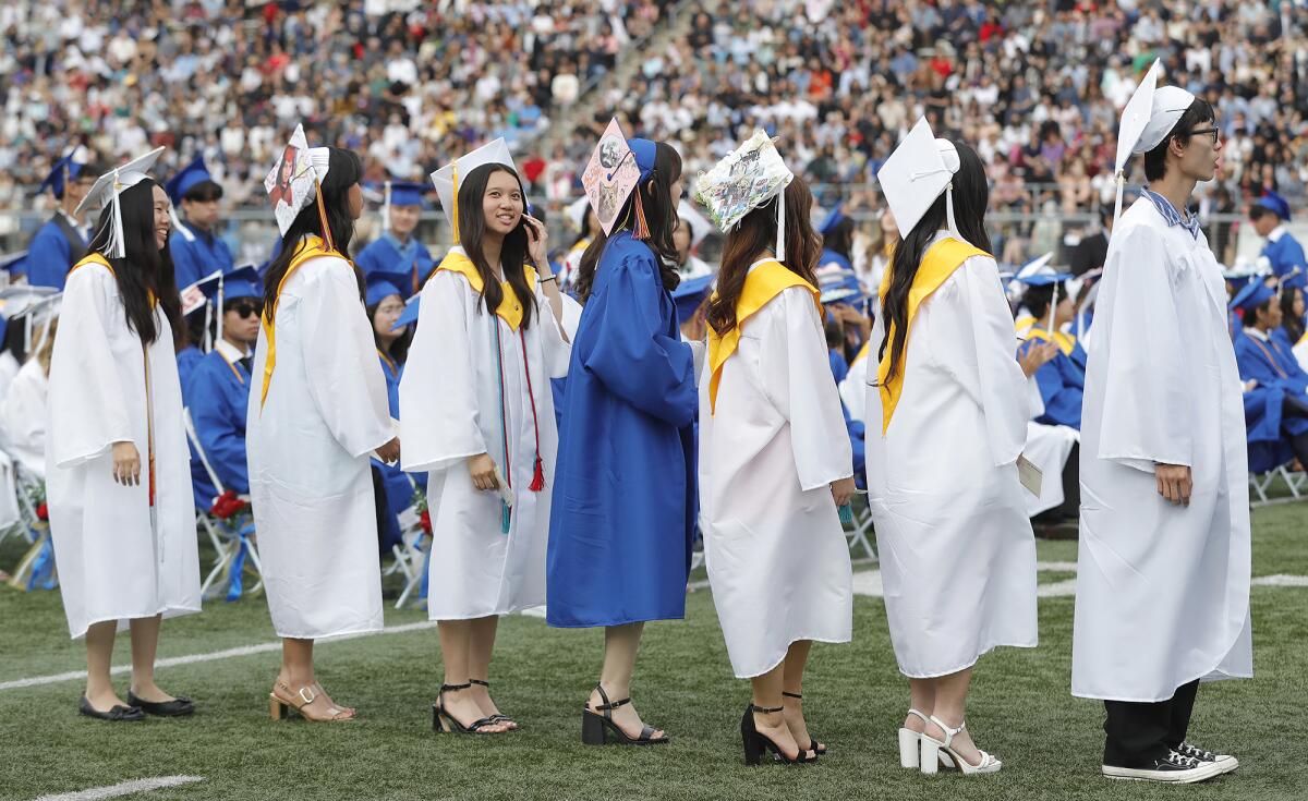Proud graduates get in line to receive their diplomas at the 2023 Fountain Valley High graduation ceremony on Wednesday.