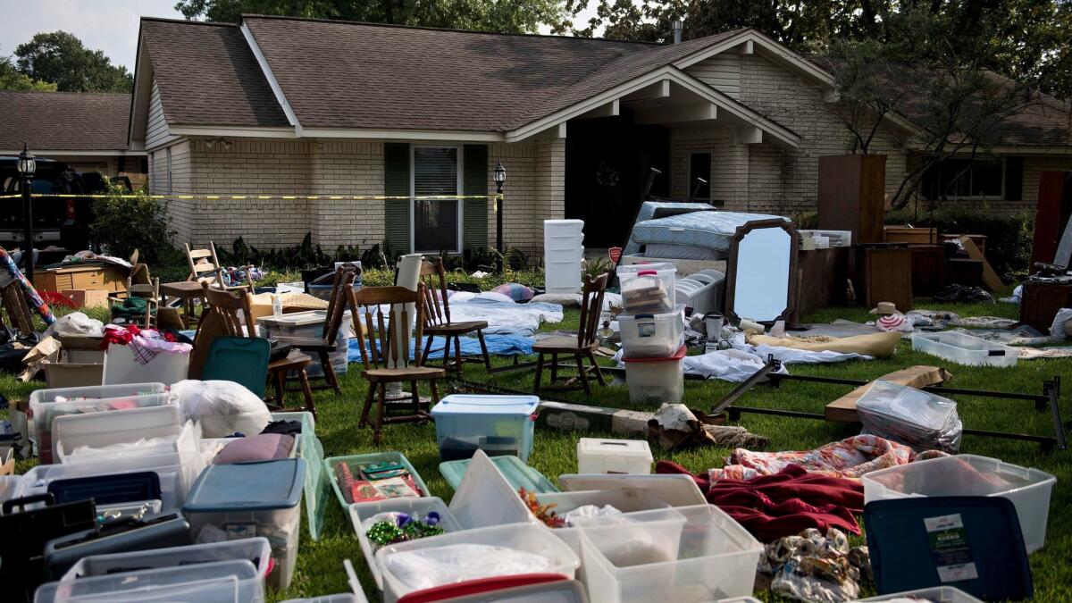 A family's possessions are spread out in the front yard for insurance adjusters as residents begin the recovery process from Hurricane Harvey.
