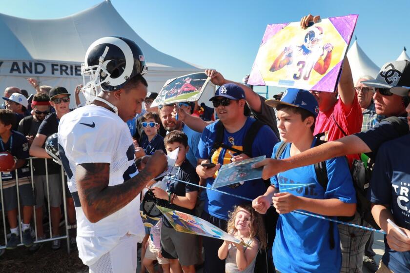 IRVINE, CALIF. -- MONDAY, AUGUST 13, 2018: Rams corner back Marcus Peters signs autographs for fans during the Los Angeles Rams training camp at UC-Irvine in Irvine, Calif., on Aug. 13, 2018. (Allen J. Schaben / Los Angeles Times)