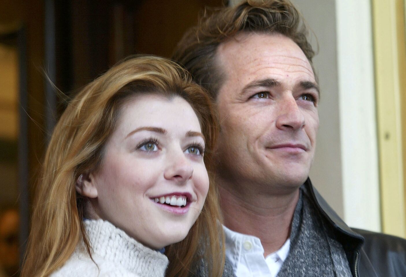 Luke Perry and Alyson Hannigan pose outside the Theatre Royal in London as they start rehearsals for a stage production of 'When Harry Met Sally..." on Jan. 8, 2004.