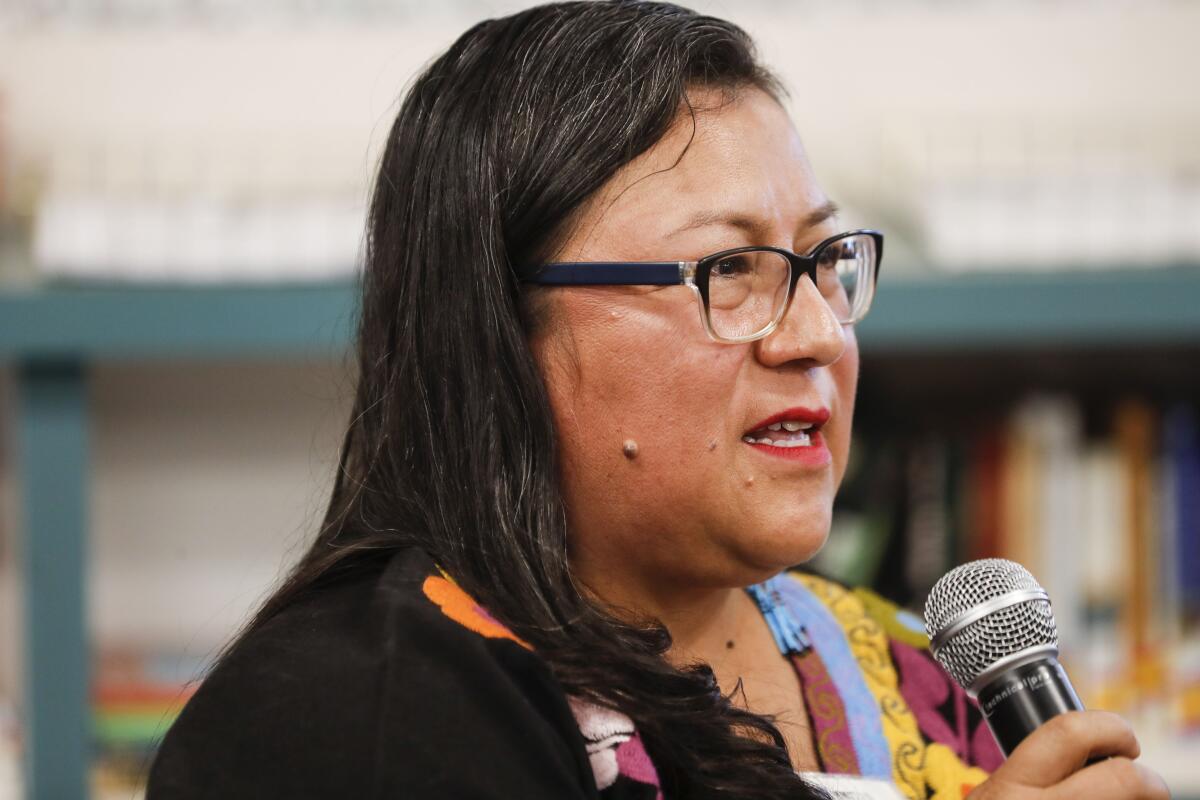 a woman speaks during a panel event