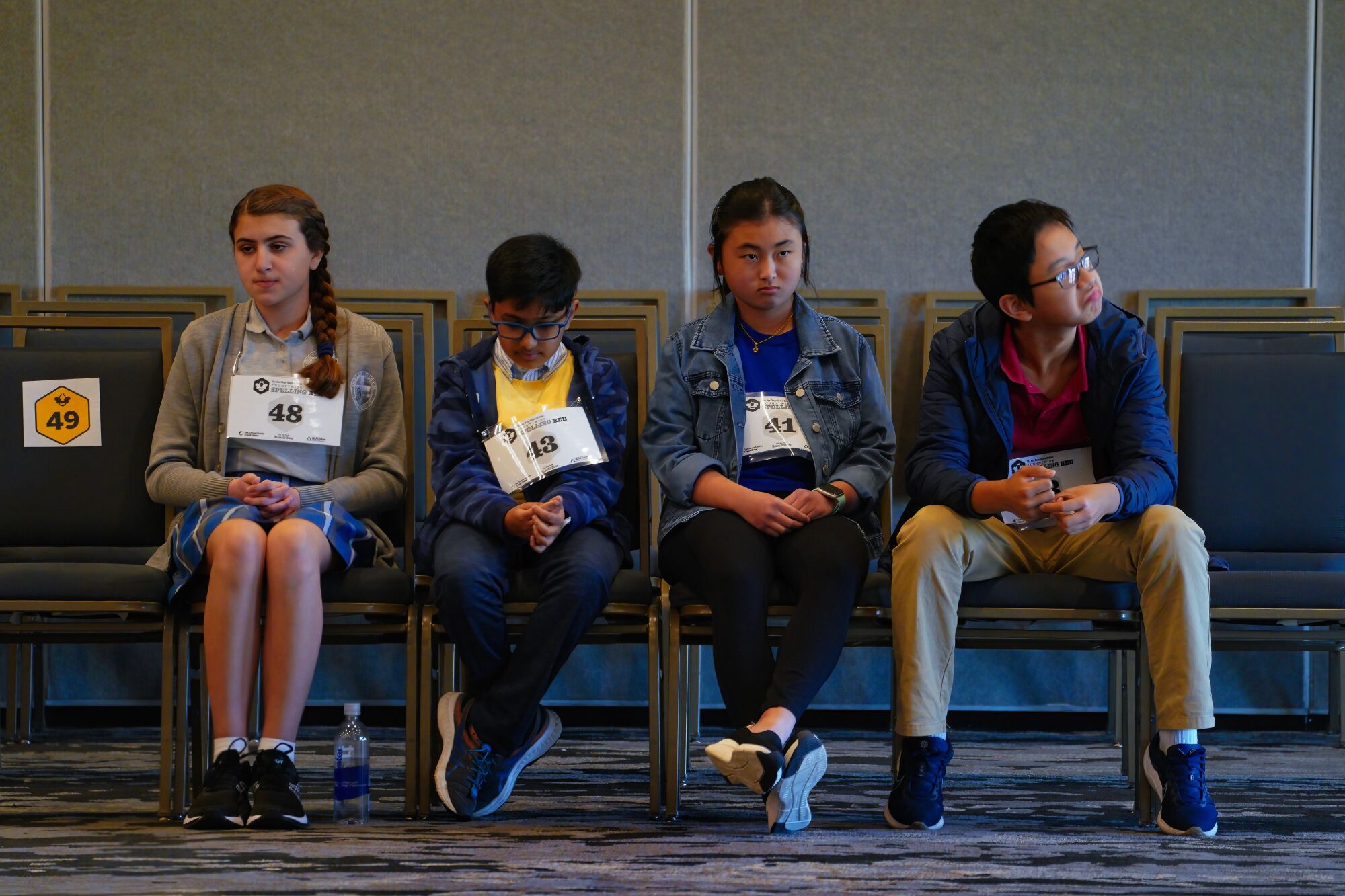 The Countywide Spelling Bee's final four sit before being called to the stage to compete.