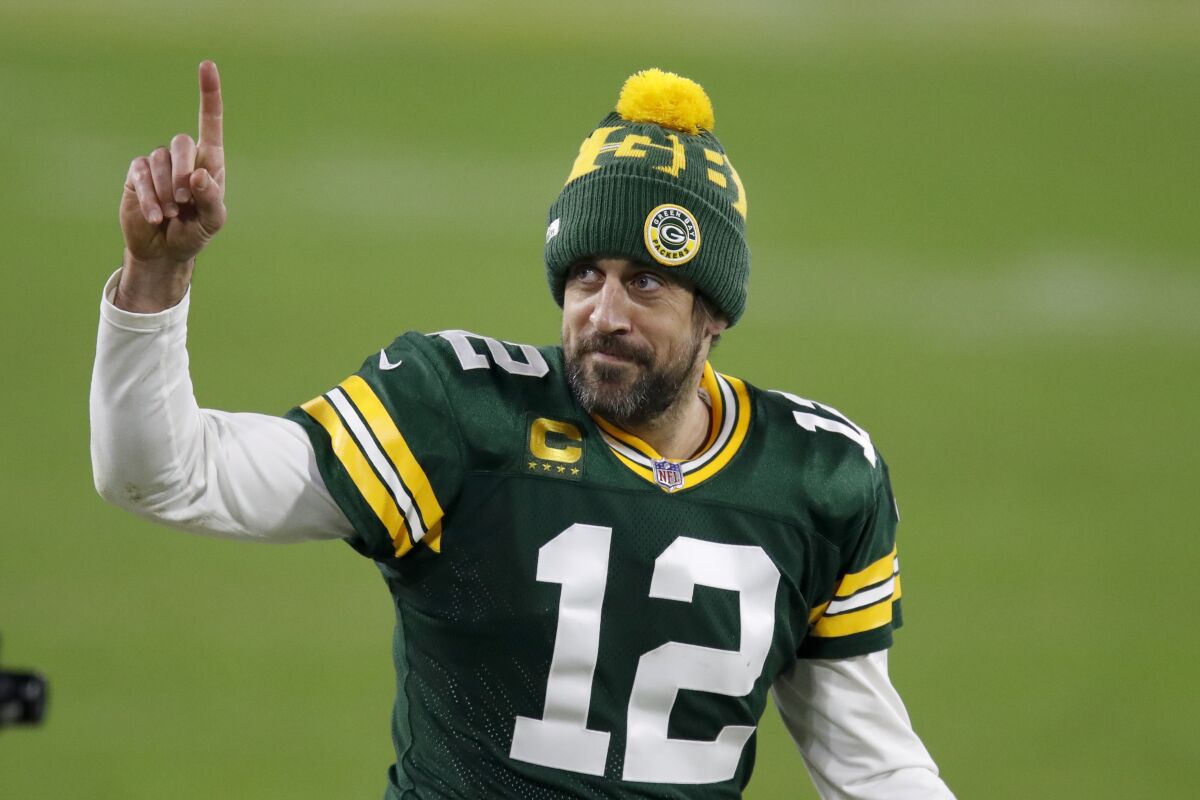 Green Bay Packers quarterback Aaron Rodgers gestures to fans after an NFL divisional playoff football game against the Rams 