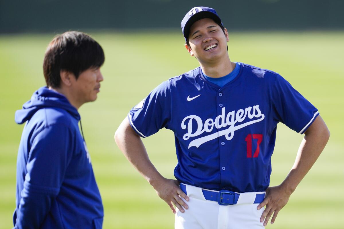 Dodgers star Shohei Ohtani and interpreter Ippei Mizuhara participate in spring training workouts in Phoenix on Feb. 18.