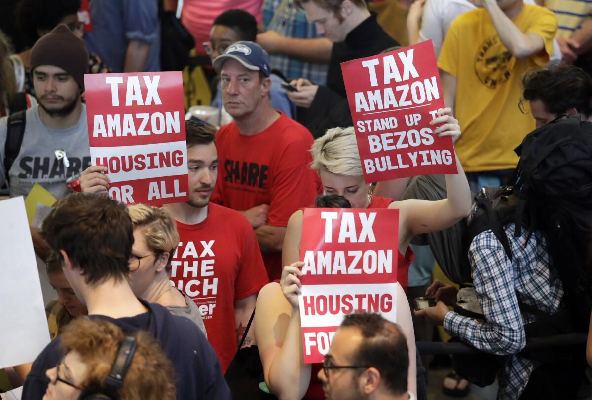 People fill a hallway before a Seattle City Council meeting in which the council voted to add a tax on high-grossing corporations.