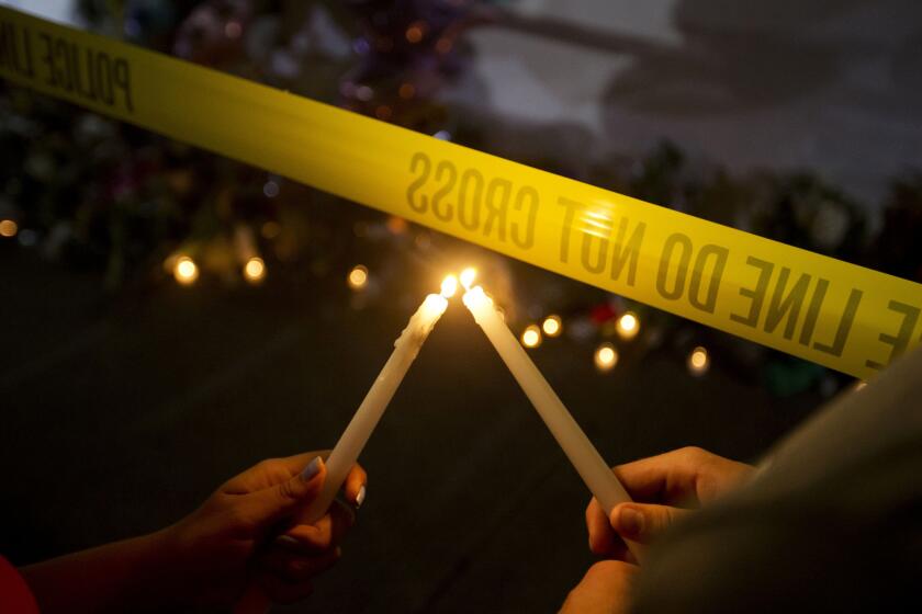 A candlelight vigil is held outside Emanuel AME Church in Charleston, S.C., where nine people were slain during Bible study a night earlier at the historic black church.