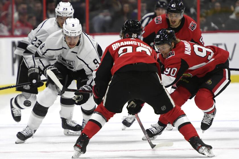 Kings left wing Adrian Kempe (9) makes his way down the ice as Senators defenseman Erik Brannstrom (26) and center Vladislav Namestnikov (90) defend during the first period of a game Nov. 7. 