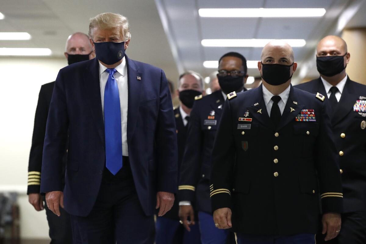 President Trump wears a mask during a visit to Walter Reed National Military Medical Center in Bethesda, Md., on Saturday.