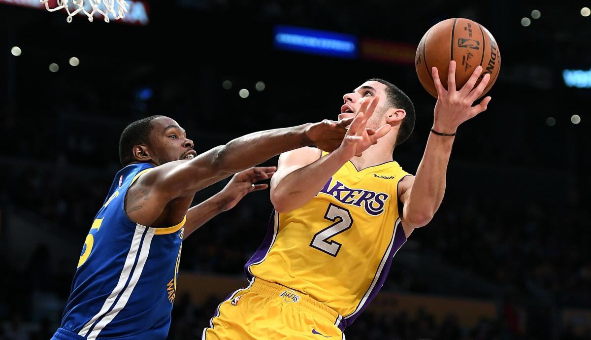 Lakers point guard Lonzo Ball, getting fouled by Warriors forward Kevin Durant during a game last season, is expected to soon join his teammates for full-court drills.