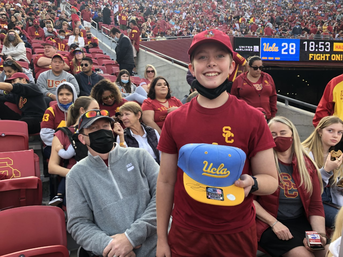 Declin Manz, 12, holds the UCLA hat Bruins quarterback Dorian Thompson-Robinson signed.