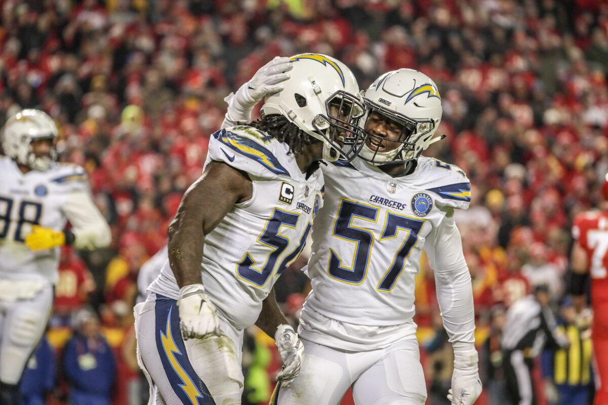 Chargers linebacker Melvin Ingram is congratulated by teammate Jatavis Brown after sacking Chiefs quarterback Patrick Mahomes to stop a drive late in the fourth quarter.