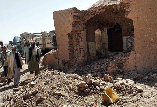 Afghan men look at a destroyed house in Azizabad village in the Shindand district of Herat province, Afghanistan. The U.S.-led coalition said it would investigate allegations of civilian deaths during a battle in western Afghanistan. Afghanistan's Ministry of Interior says that at least 70 civilians were killed in strikes in the Shindand district. More photos >>>