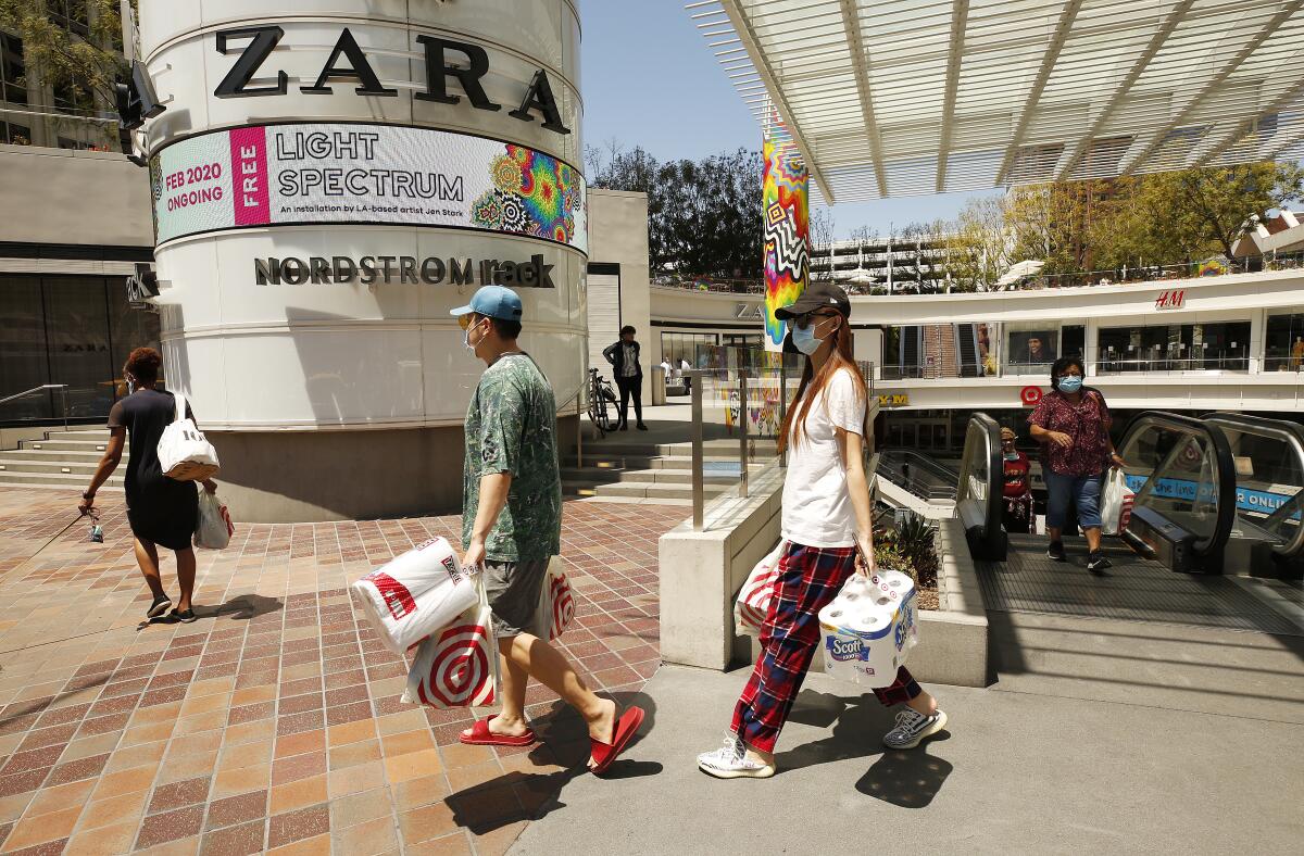 Shoppers were out Tuesday at the FIGat7th open-air mall in downtown L.A., where the food court and several businesses are open.