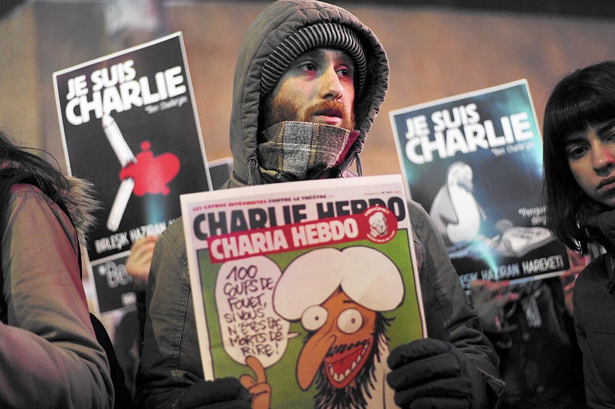 People hold placards reading "I am Charlie" and frontpage of Charlie Hebdo during a march in Istiklal avenue in Istanbul on January 8, 2015 in tribute to the 12 victims of an attack by armed gunmen on the offices of French satirical newspaper Charlie Hebdo in Paris the day before. Wednesday's massacre triggered poignant and spontaneous demonstrations of solidarity around the world and more than 100,000 poured onto the streets of France, as the manhunt for the two suspects stretched into the night with search-and-seizure operations in Strasbourg and towns near Paris. AFP PHOTO/OZAN KOSEOZAN KOSE/AFP/Getty Images ** OUTS - ELSENT, FPG - OUTS * NM, PH, VA if sourced by CT, LA or MoD **