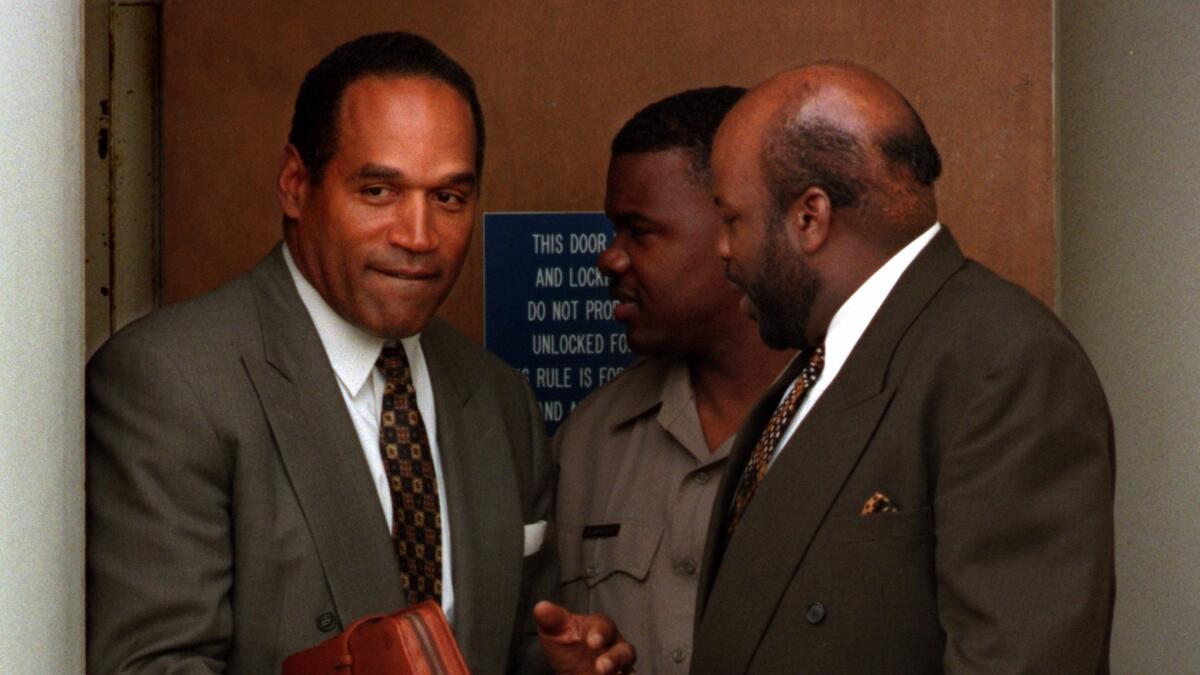 O.J. Simpson leaves the Santa Monica courthouse while the jury deliberates in his civil trial in 1997. (Carolyn Cole / Los Angeles Times)