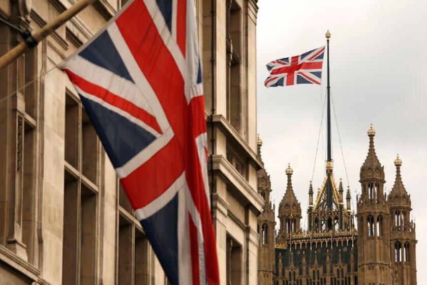 Flags fly at the Palace of Westminster in London. A $555 round-trip fare puts the capital within reach.