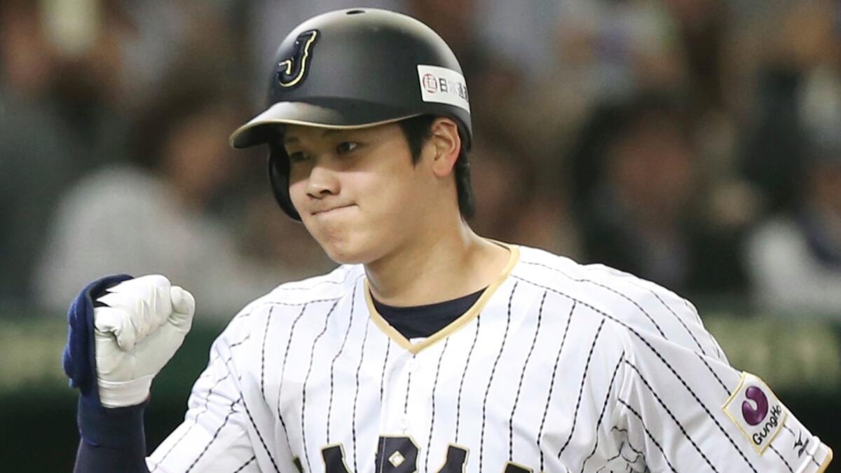 Japan's Shohei Ohtani reacts after hitting a solo home run against the Netherlands during an international exhibition series baseball game at Tokyo Dome on Nov. 12, 2016.