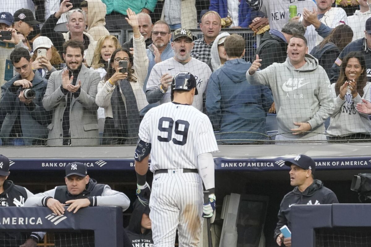 Fans cheer New York Yankees' Aaron Judge walks to the dugout after striking out in the eighth inning of a baseball game against the Baltimore Orioles, Saturday, Oct. 1, 2022, in New York. (AP Photo/Mary Altaffer)