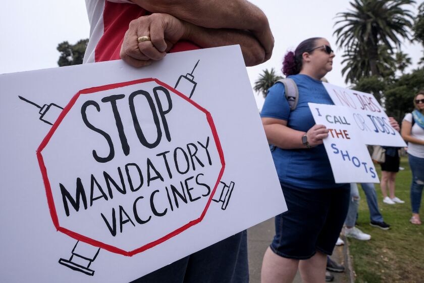 Anti-vaccination protesters holding signs take part in a rally against Covid-19 vaccine mandates, in Santa Monica, California, on August 29, 2021. (Photo by RINGO CHIU / AFP) (Photo by RINGO CHIU/AFP via Getty Images)