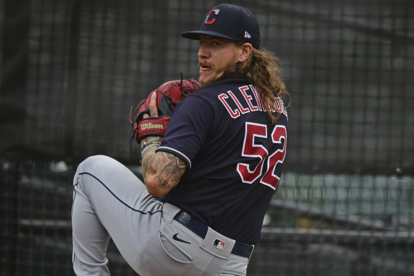 Cleveland Indians starting pitcher Mike Clevinger warms up in the bullpen before a simulated baseball game, Friday, July 10, 2020, in Cleveland. (AP Photo/David Dermer)