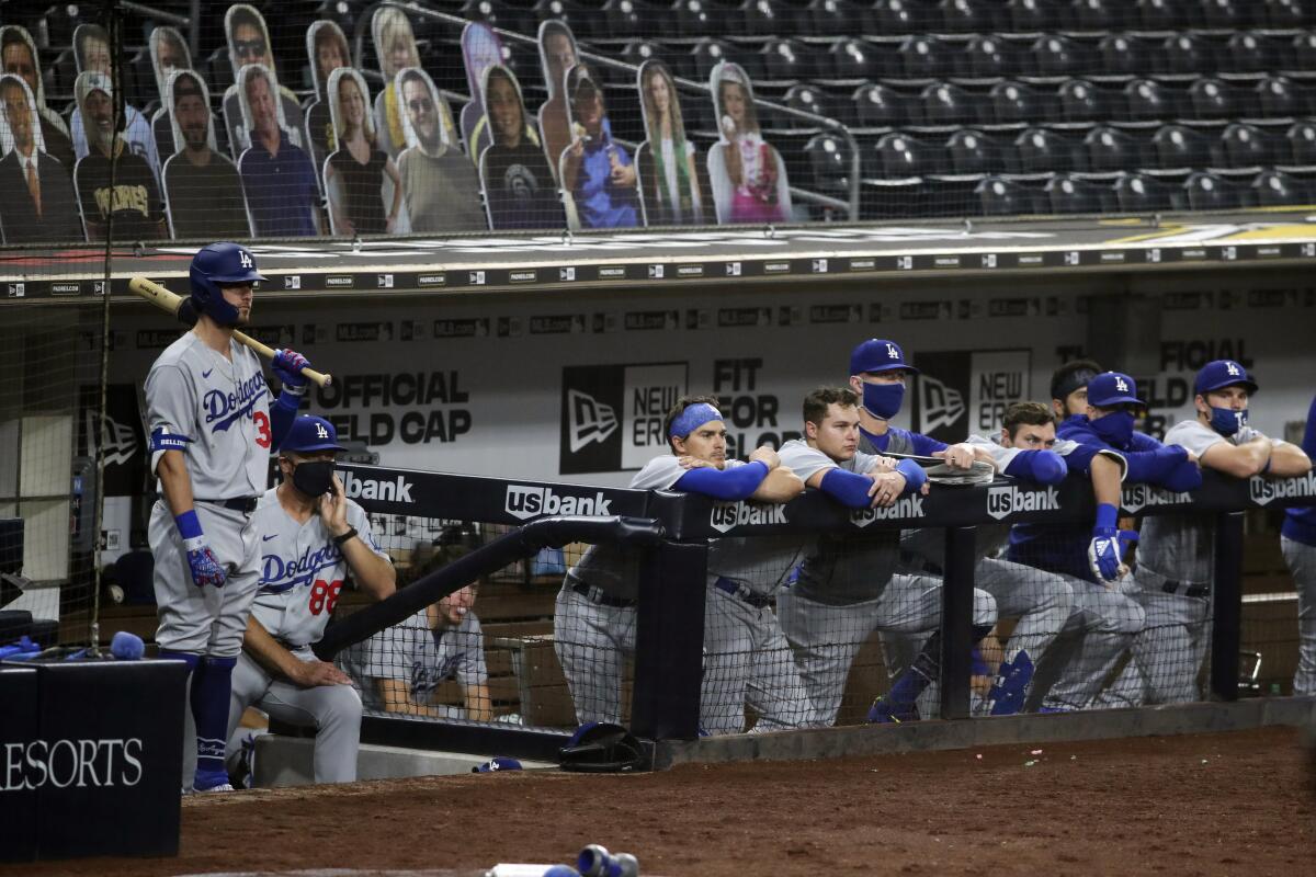 The Dodgers watch from the dugout Monday while playing the Padres at Petco Park, the future site of MLB playoff games.