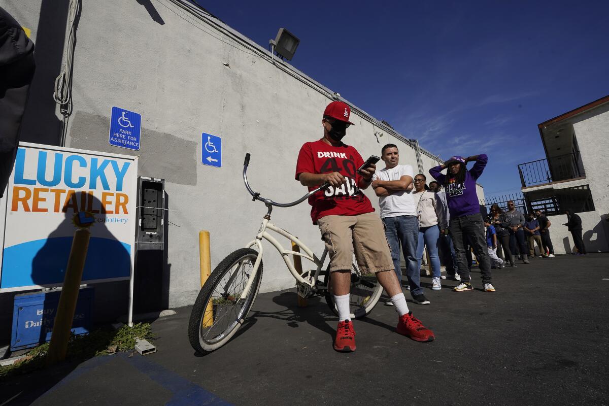 Jose Garcia waits in line to purchase Powerball tickets at the Bluebird Liquor store in Hawthorne on Saturday.