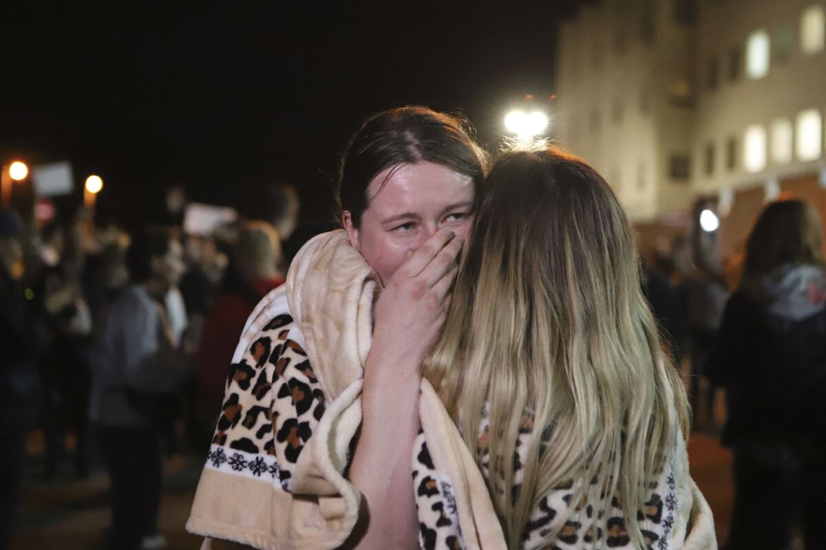 Relatives hug after being released from a detention center where protesters were detained during a mass rally following presidential election in Minsk, Belarus, Friday, Aug. 14, 2020. Nearly 7,000 people have been detained and hundreds injured in the clampdown on demonstrators protesting the official results that said Lukashenko won 80% of the vote and his top opposition challenger got only 10%. Police have broken up protests with stun grenades, tear gas, rubber bullets and severe beatings. (AP Photo)