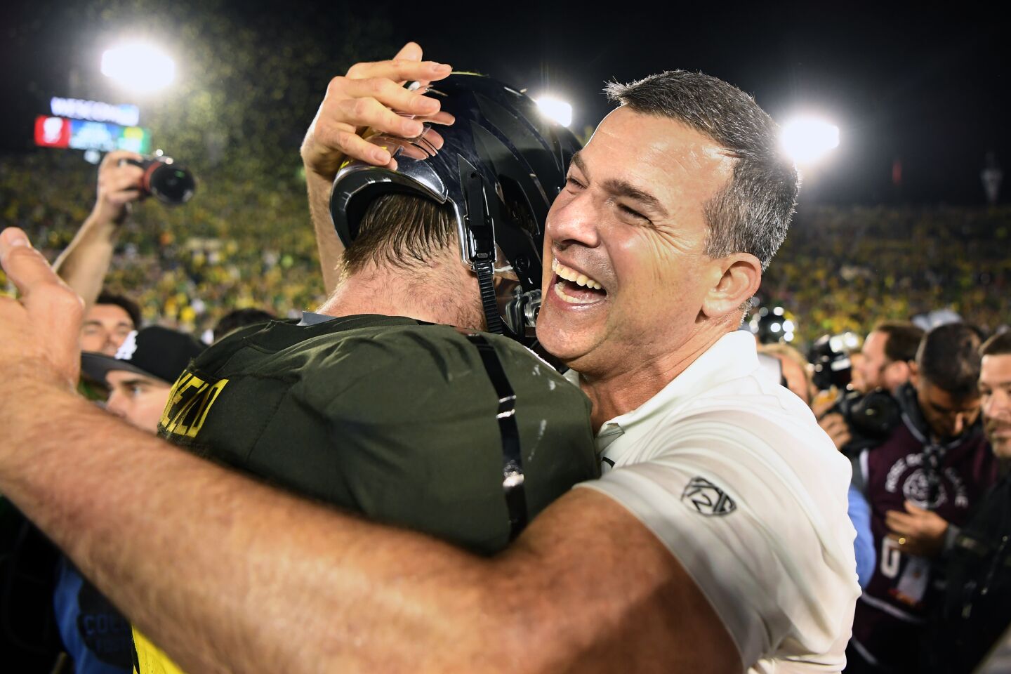 Oregon coach Mario Cristobal hugs a player after the Ducks' win over Wisconsin in the Rose Bowl.