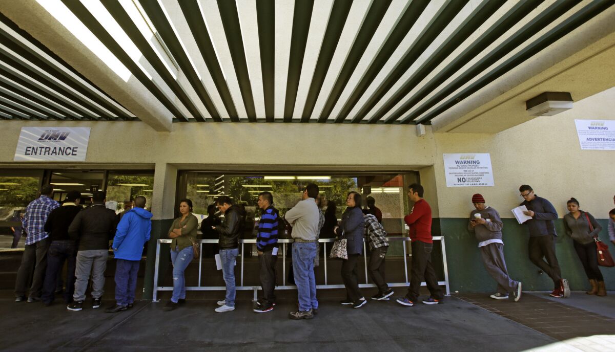 Customers wait in line at a DMV office in Lincoln Park in Los Angeles.