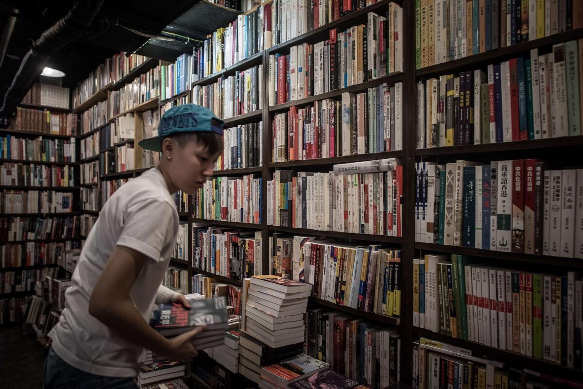 An employee arranges books about Chinese politics in a Hong Kong store in January 2016.