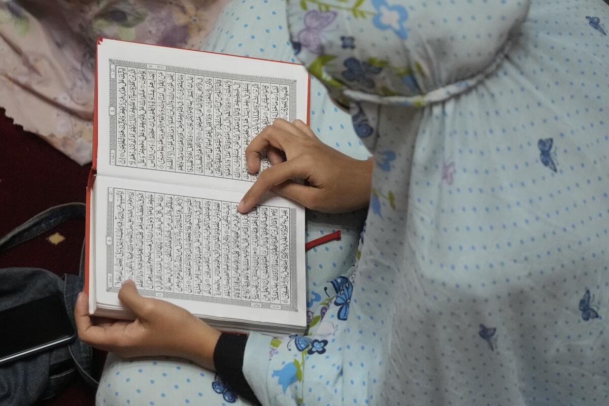 A Muslim woaman reads the Quran during an evening prayer in Jakarta, Indonesia.