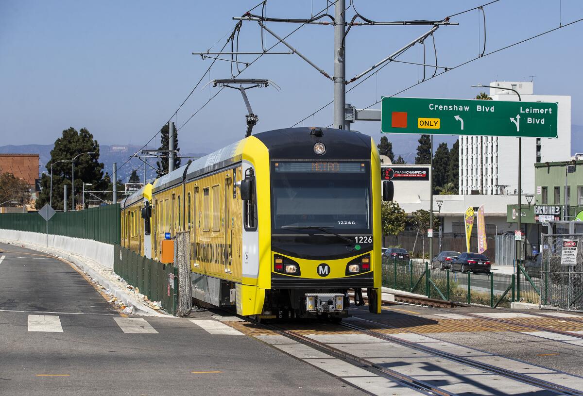 A metro train, traveling on the new K Line, makes its way along Crenshaw Blvd. in Los Angeles, during a test run. 