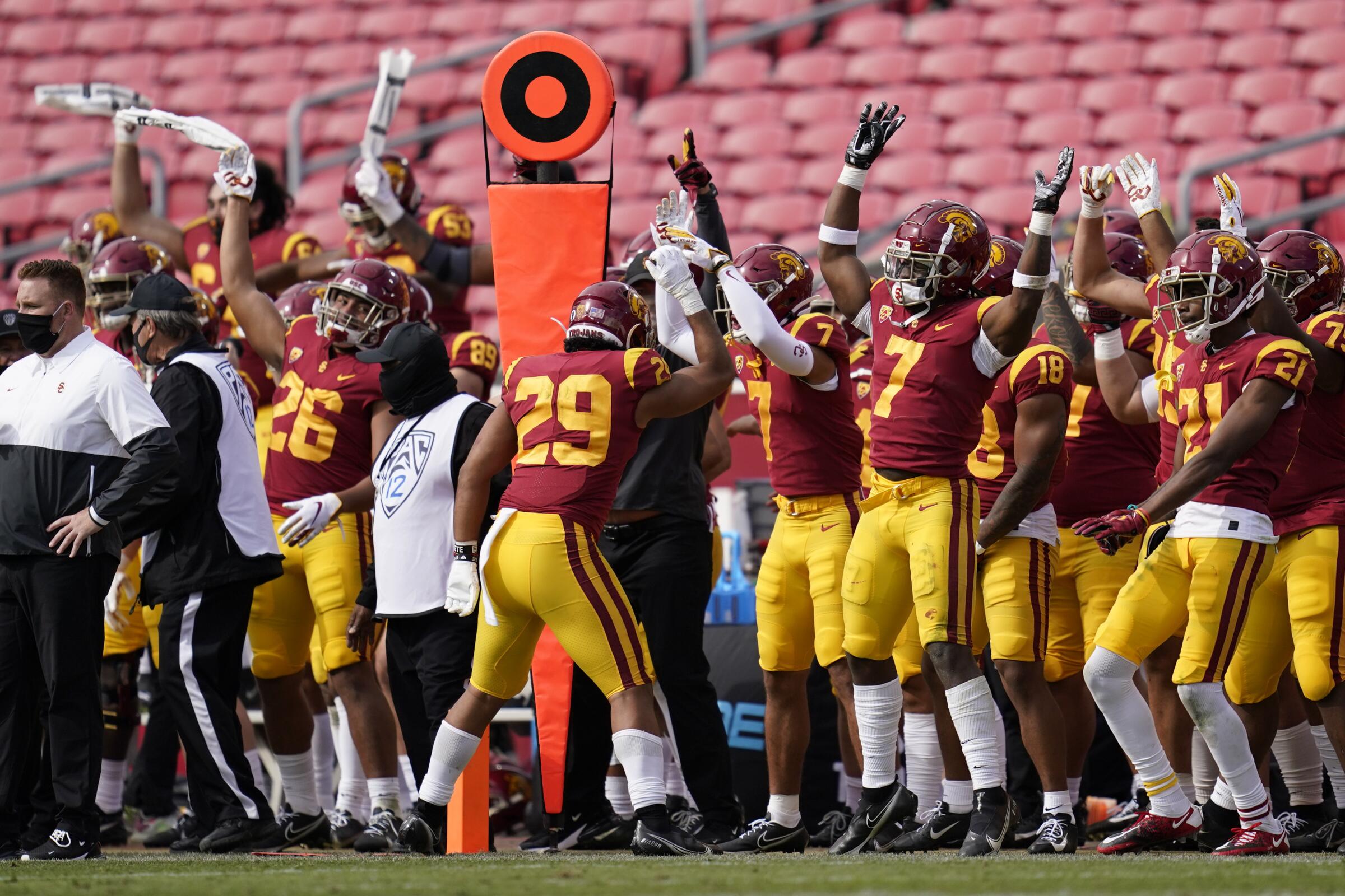 USC players celebrate on the sideline during the second half of the Trojans' 28-27 win over Arizona State on Saturday.