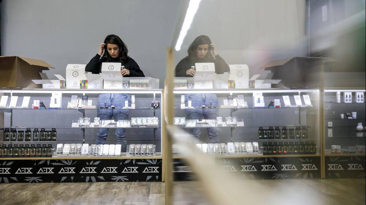 An employee stocks the shelves with cannabis products at Delta-9 THC in Wilmington, Calif. on Dec. 26, 2018.