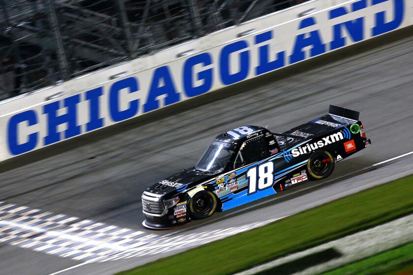 NASCAR driver Kyle Busch crosses the finish line to win the Camping World Truck Series race Friday night.