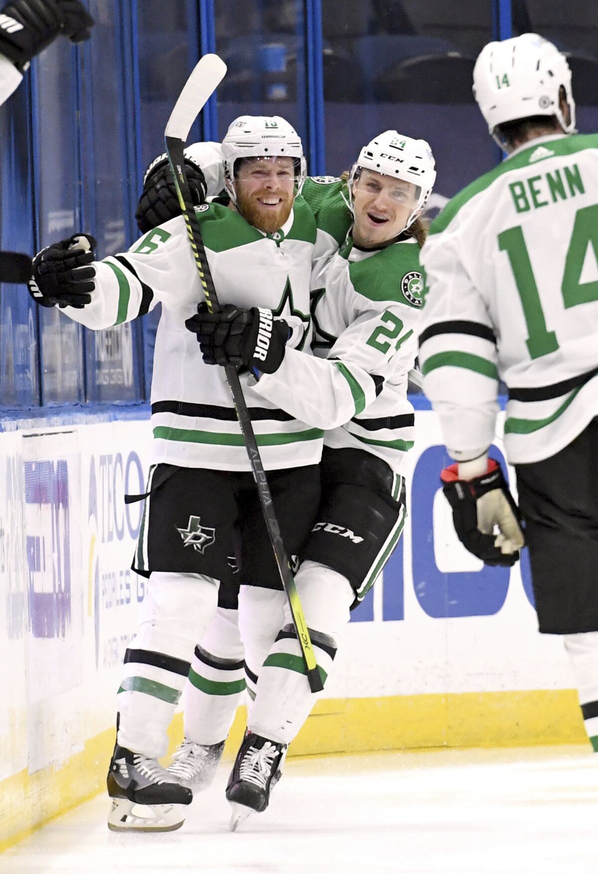 Dallas Stars center Joe Pavelski (16) and left wing Roope Hintz (24) celebrate a goal by Pavelski during the second period of an NHL hockey game against the Tampa Bay Lightning, Friday, May 7, 2021, in Tampa, Fla. (AP Photo/Jason Behnken)