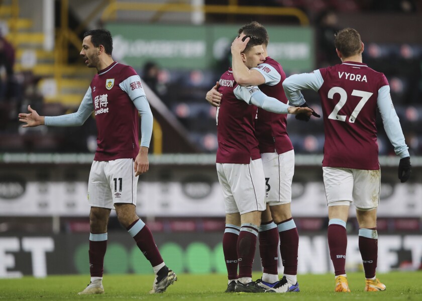 Burnley's Johann Berg Gudmundsson , center, celebrates with teammates after scoring his sides first goal during the English Premier League soccer match between Burnley and Brighton at Turf Moor stadium in Burnley, England, Saturday, Feb. 6, 2021. (Molly Darlington/Pool via AP)